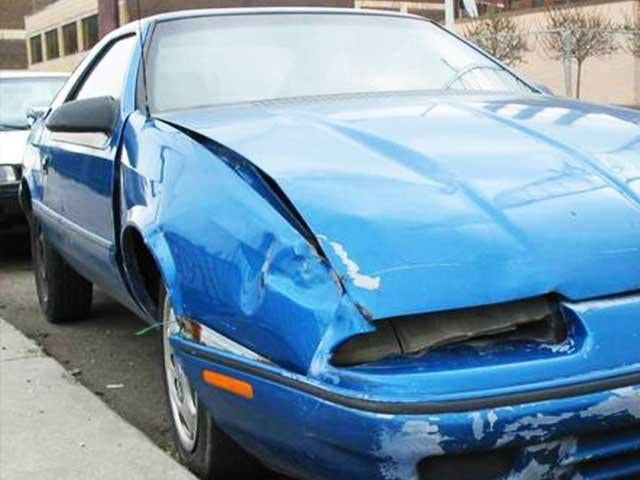 front of blue sports car with some visible damage