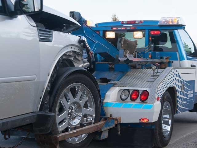 vehilce being towed behind a tow-truck